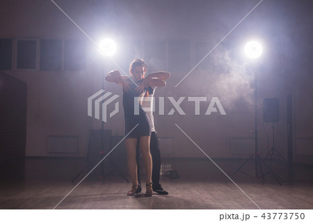 Young couple dancing social danse kizomba or bachata or semba or taraxia in dancing class background Young couple dancing social danse kizomba or bachata or semba or taraxia in dancing class background 43773750