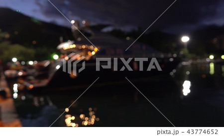 Defocused moored luxury motor yacht at marina at night Defocused moored luxury motor yacht at marina at night 43774652