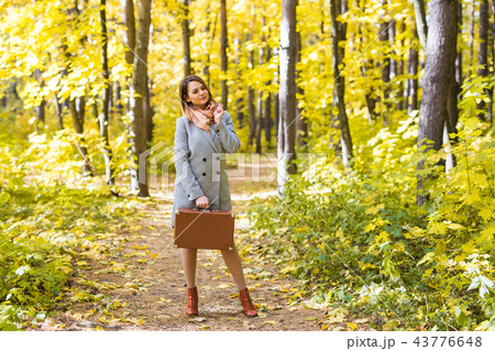 Season, fall and people concept - Portrait of a beautiful young woman in autumn nature Season, fall and people concept - Portrait of a beautiful young woman in autumn nature 43776648