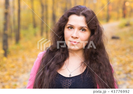 People, season and style concept - beautiful plus size woman smiling in autumn park People, season and style concept - beautiful plus size woman smiling in autumn park 43776992