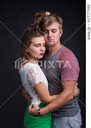 Lovers kissing each other on black background 43777366