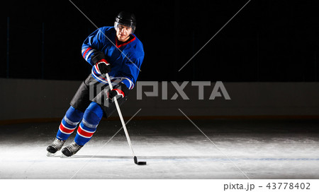 Young hockey player skating on rink in attack Young hockey player skating on rink in attack 43778402