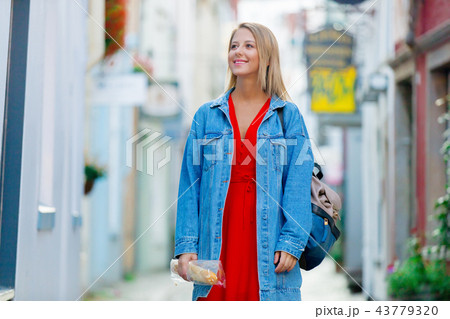 Young lady in jeans jacket on medieval street of Bremen Young lady in jeans jacket on medieval street of Bremen 43779320