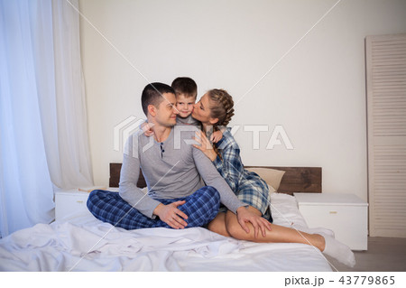 mom dad and son in the morning in the bedroom on the bed mom dad and son in the morning in the bedroom on the bed 43779865