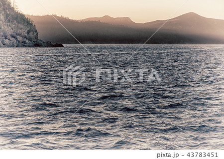 the sunrise in the ocean near the mountain the sunrise in the ocean near the mountain 43783451