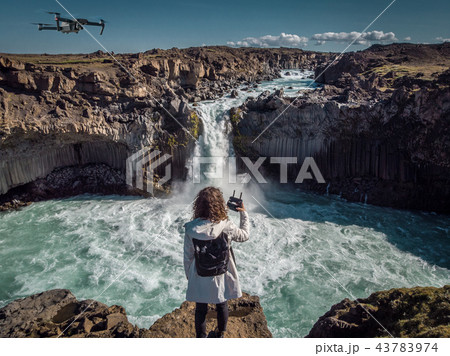 Woman stay on waterfall in Iceland, hide waterfall in Iceland, amazing sights and places to explore 43783974