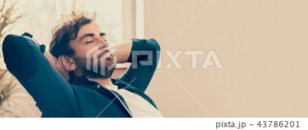Young man relaxing in his chair 43786201