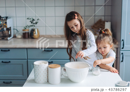 two little girls cook in the kitchen two little girls cook in the kitchen 43786297