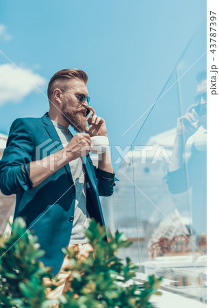 Serene man telling on mobile during break 43787397