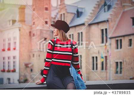 Young girl red sweater, in hat at streets of Bruges, 43789835