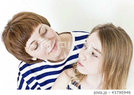 Beautiful mother and daughter on white 43790946