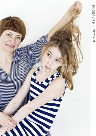 Beautiful mother and daughter on white 43790948