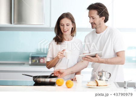 Couple cooking breakfast Couple cooking breakfast 43790979
