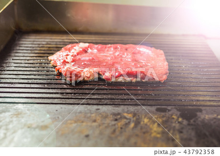 Food and cooking concept - Close up of a steak on grill Food and cooking concept - Close up of a steak on grill 43792358