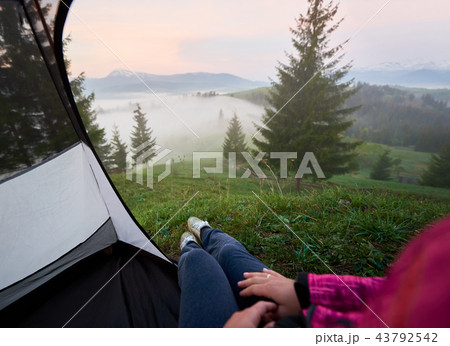 Tourist tent with woman legs in jeans and running shoes Tourist tent with woman legs in jeans and running shoes 43792542