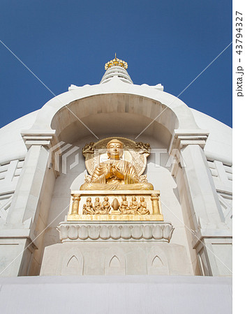 Gilded bas-relief of Buddha in a dharmachakra 43794327