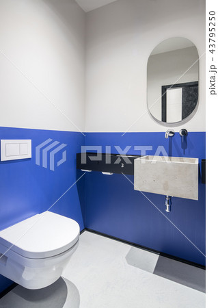 Restroom with multicolor walls and concrete sink Restroom with multicolor walls and concrete sink 43795250
