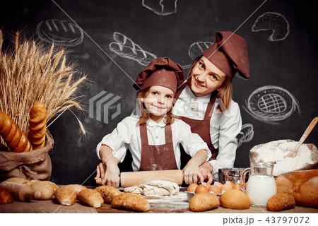 Woman and girl making pastries together Woman and girl making pastries together 43797072