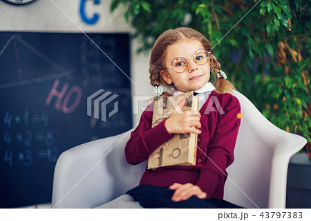 Learning concept with cute little girl holding a book 43797383