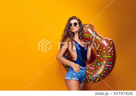 Woman in swimsuit with swim ring Woman in swimsuit with swim ring 43797828