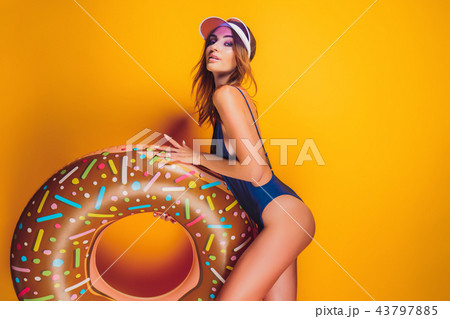 Woman in swimsuit with swim ring Woman in swimsuit with swim ring 43797885