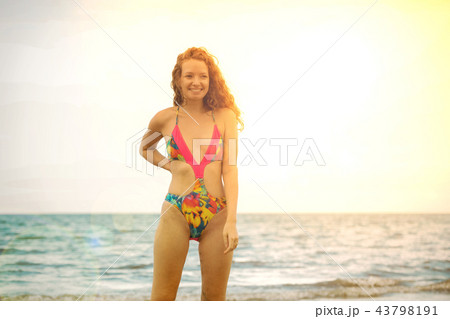 Young woman practices yoga on the beach in summer. Young woman practices yoga on the beach in summer. 43798191