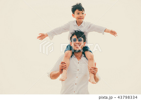 Happy father carrying his son on the neck. Happy father carrying his son on the neck. 43798334