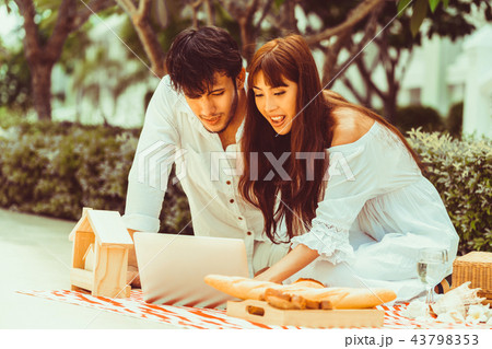Young couple go picnic at the park in summer. 43798353