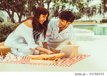 Young couple go picnic at the park in summer. 43798355