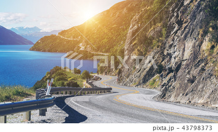Winding Road along Mountain Cliff and Lake 43798373