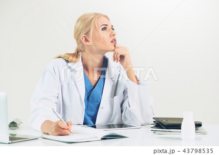 Doctor in hospital working on medical report. 43798535