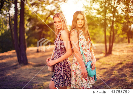Beautiful women standing in park Beautiful women standing in park 43798799