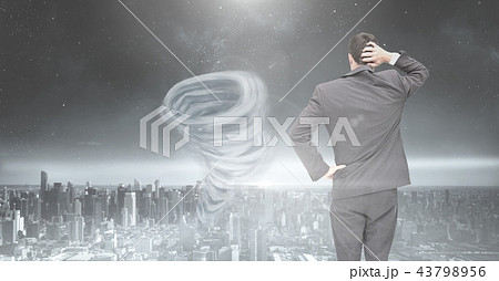 Tornado twister painted and dark city sky with businessman 43798956