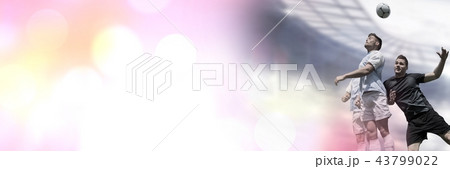 Soccer players heading football in stadium 43799022