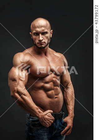 bodybuilder posing. Beautiful sporty guy male power. Fitness muscled man bodybuilder posing. Beautiful sporty guy male power. Fitness muscled man 43799172