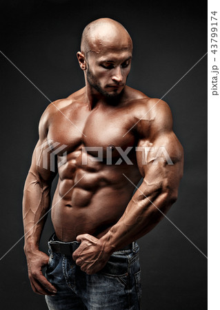 bodybuilder posing. Beautiful sporty guy male power. Fitness muscled man 43799174