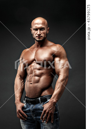 bodybuilder posing. Beautiful sporty guy male power. Fitness muscled man 43799175