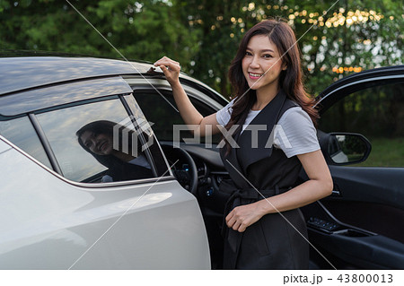 woman standing and open the car door woman standing and open the car door 43800013