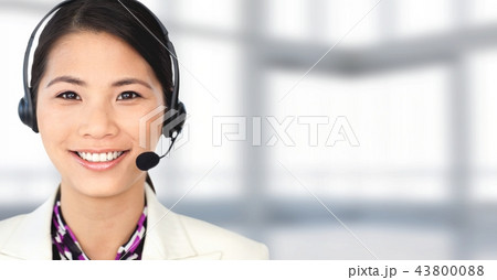 Customer service woman with bright background in call center 43800088
