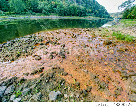 Low water level, empty river inflow. Muddy water 43800526