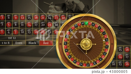 Roulette wheel and table numbers in front of casino background 43800805