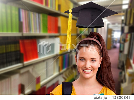 Student woman in education library with graduation hat Student woman in education library with graduation hat 43800842
