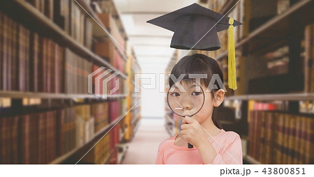 School girl in education library with graduation hat 43800851