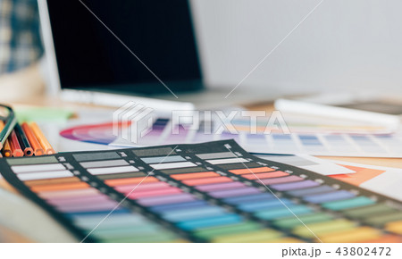 Designer's equipment is placed on the desk. 43802472