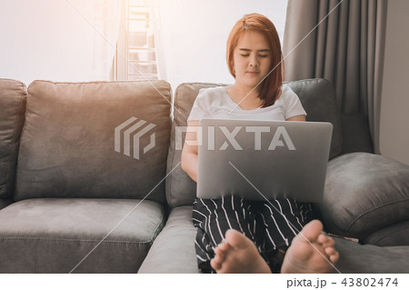 Attractive young asian woman using laptop at home. 43802474