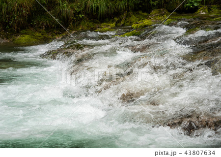 A river of clear water flows fast 43807634
