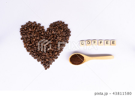 coffee bean in shape of heart with wooden spoon coffee bean in shape of heart with wooden spoon 43811580