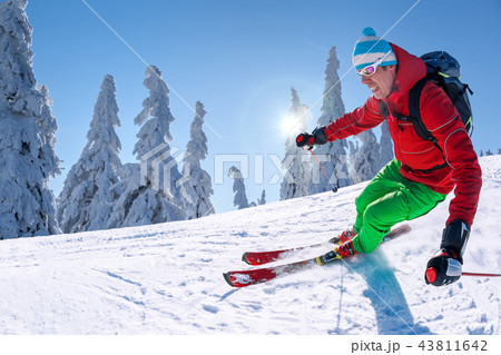 Skier skiing downhill in high mountains Skier skiing downhill in high mountains 43811642