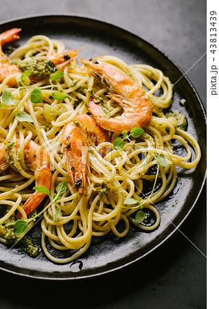 Spaghetti with pesto and prawns served on plate Spaghetti with pesto and prawns served on plate 43813439