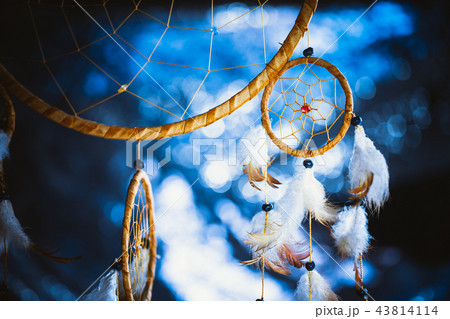 Dreamcatcher against a white blur of snow 43814114